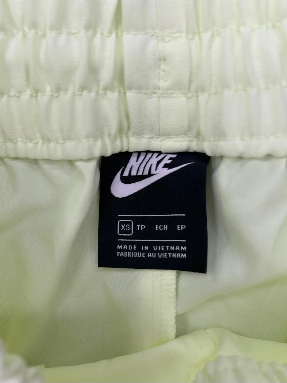 Nike Women's Sportswear Woven Pants in a bright neon green/yellow XS